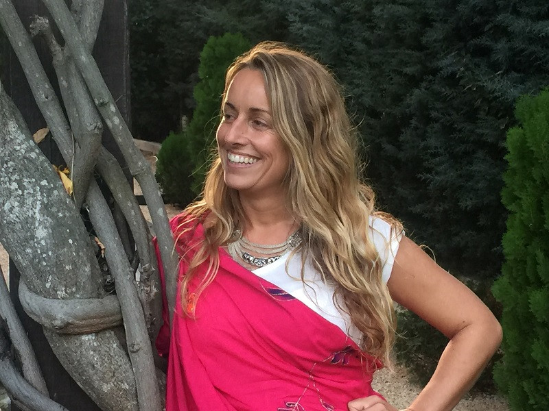 Tantra practitioner in a meditative pose with a blurry background.
